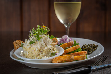 Fish dip with toast, diced onions and capers.