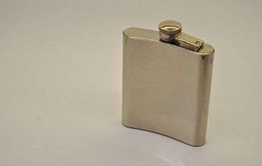 metal flask for alcohol on a light background