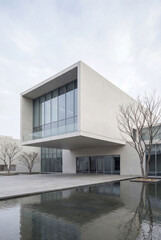 This stunning image showcases a modern architectural design featuring sleek concrete surfaces, expansive glass walls, and an inviting water feature that enhances tranquility.