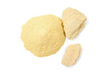 Yellow cosmetic clay in pieces and powder - top view.
