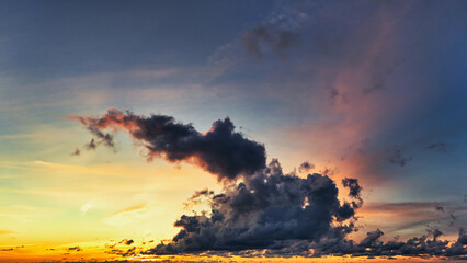 Dramatic Contrast of Dark Clouds Against a Fiery Sunset Sky