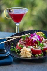 Tuna wrapped sushi roll with berry cocktail.