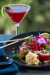 Tuna wrapped sushi roll with berry cocktail.