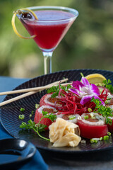 Tuna wrapped sushi roll with berry cocktail.