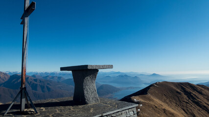 iron cross on poggio croce summit during winter, italy