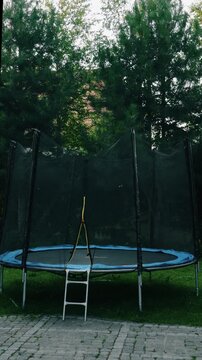 A colorful trampoline in an outdoor setting, perfect for children and adults to jump, play, and have fun safely.