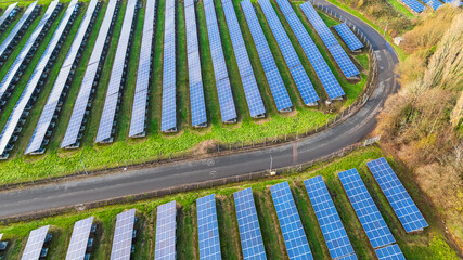 A side view of a solar farm with the sky reflecting off the panels, clean renewable energy in Wolverhampton, UK