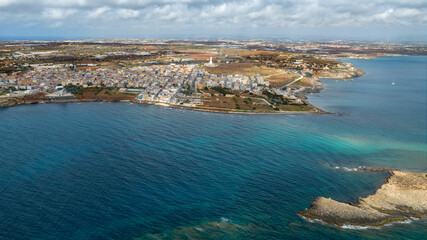 Aerial view of the coastal village of Portopalo di Capo Passero, located in the province of Syracuse, Sicily, Italy. It is a small town overlooking the turquoise sea.