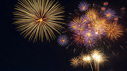 Fototapeta premium Vibrant golden and purple fireworks bursting in a dark night sky