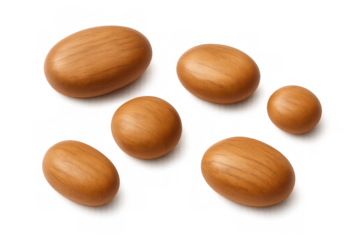 Argan nuts lying on transparent background, symbolizing natural cosmetics ingredient, healthy food, and beauty products