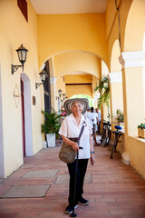 Senior travel. Senior woman at the beautiful heritage town of Mompox wearing the traditional Sombrero vueltiao.