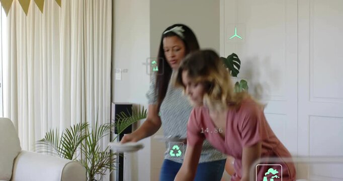 Two women entering doorway carrying bowl and plates, arranging party, green CO2 overlays following