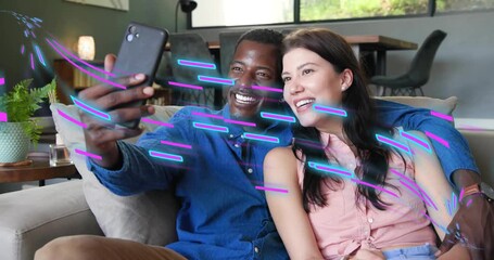 Man holding phone posing for selfie, woman waving, neon glitches moving across faces, showing tech - Powered by Adobe