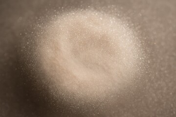 Delicate burst of soft beige cosmetic powder suspended in air, highlighting fine particles, gentle diffusion, and refined luxury beauty aesthetics in a clean modern style.