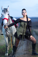 Charming European lady posing with a majestic white horse in an open field, symbolizing freedom, calmness, and connection with nature.