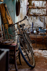 Vintage Bicycle in Rustic Abandoned Workshop with Weathered Walls and Antique Tools
