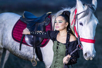 Charming European lady posing with a majestic white horse in an open field, symbolizing freedom, calmness, and connection with nature.