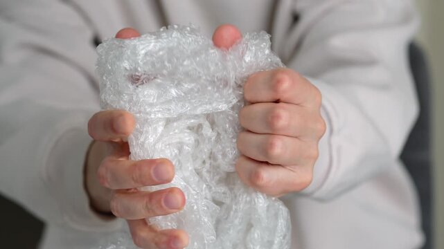 A close-up of a bubble wrap in a person's hands.
Wrap to protect goods from damage and preserve their safety.
Transparent bubble wrap