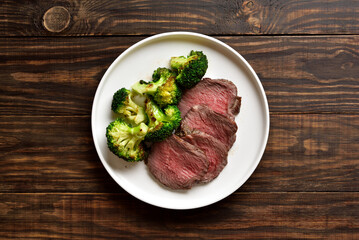 Beef steak served with roasted broccoli