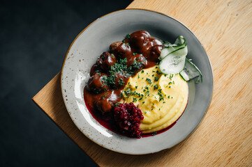Swedish meatballs with mashed potatoes, gravy and lingonberries on a plate