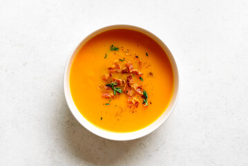 Pumpkin and carrot soup with roasted bacon and thyme