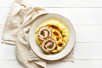 Slices of pork roll with mushrooms, cheese, sun dried tomatoes