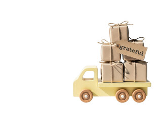 Toy truck carrying wrapped gifts with a grateful tag isolated on transparent background