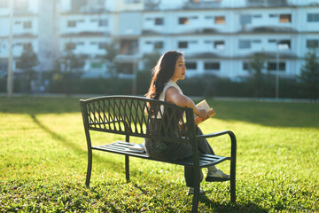 Woman sitting on park bench enjoying leisure time