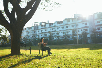 Woman reading a book in an urban park