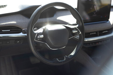Steering wheel of electric vehicle, interior, cockpit, electric buttons. Autonomous car. Driverless car. Self-driving vehicle. Empty cockpit electric vehicle, Head Up Display and digital speedometer
