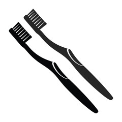 Two black toothbrushes are displayed diagonally on a plain white background