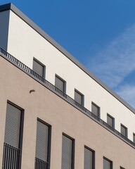 Facade of a modern building in the sun with blue sky