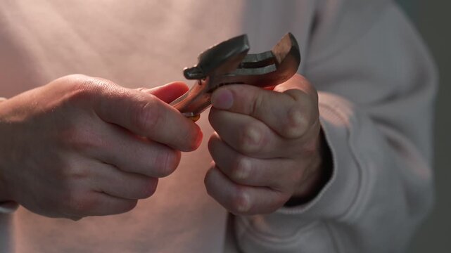 A mechanic holding an adjustable wrench.
A mechanic holding a wrench.
Plumber's equipment.
Fixing a breakdown with a wrench.