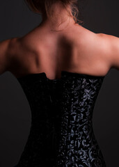 A woman's back in a black corset