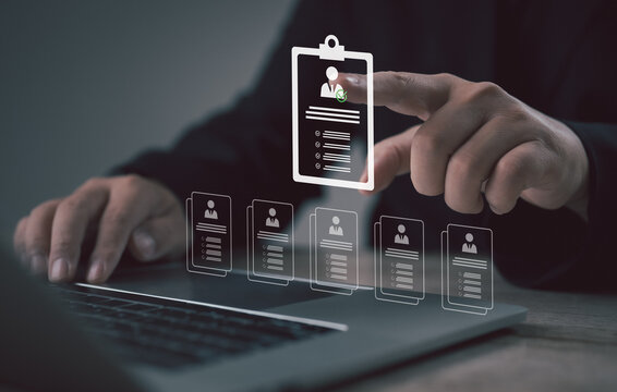 A recruiter using a digital interface to review candidate profiles on a laptop, highlighting a selected applicant. The scene represents modern hiring, screening, evaluation, and talent selection proce