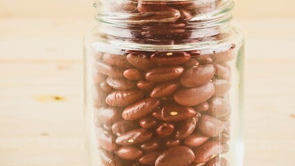 Glass jar filled with red kidney beans close up