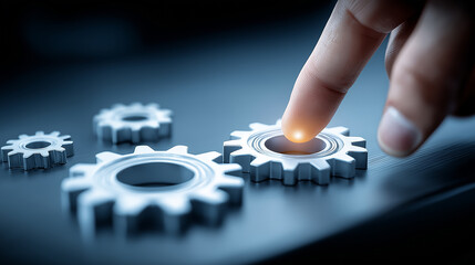 Human Finger Touching Illuminated Gear on Dark Background