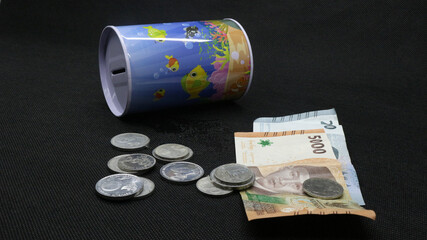 Piggy bank with scattered coins and bills