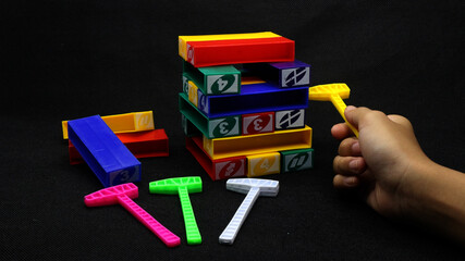 Colorful uno stacko blocks on black background