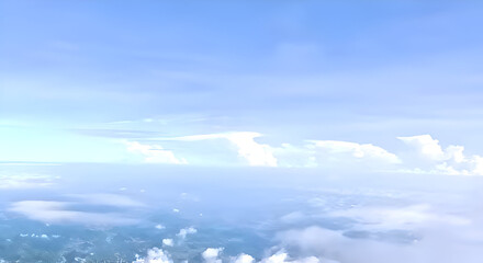 a view of a bright blue sky decorated with thin white clouds