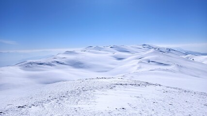 Snow-covered mountains beneath a blue sky – a Sahara-like winter scene