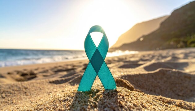 Teal awareness ribbon for ovarian cancer, anxiety, and PTSD support, standing proudly on a sandy beach during a beautiful golden sunset