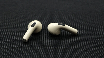 Wireless Ear buds on black background