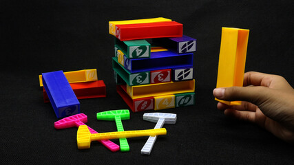 Colorful uno stacko blocks on black background
