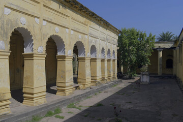 Obraz premium long, weathered side verandah of 'nasipur palace' with ornate yellow columns and cusped arches