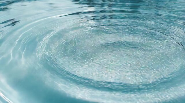 Close-up video of clear blue water surface with gentle ripples and concentric waves, creating a serene and calming abstract background texture for spa, purity, or liquid concepts