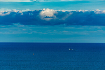 Stunningly beautiful sunset over the ocean as seen from the cape cliffs near the lighthouse of Vik, small city in Southern Iceland, travel tourist destination and sightseeing