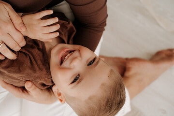 New Year, family, mother and child hugging and kissing near a Christmas tree, having fun together, preparing for the New Year, waiting for the holiday, family New Year photo