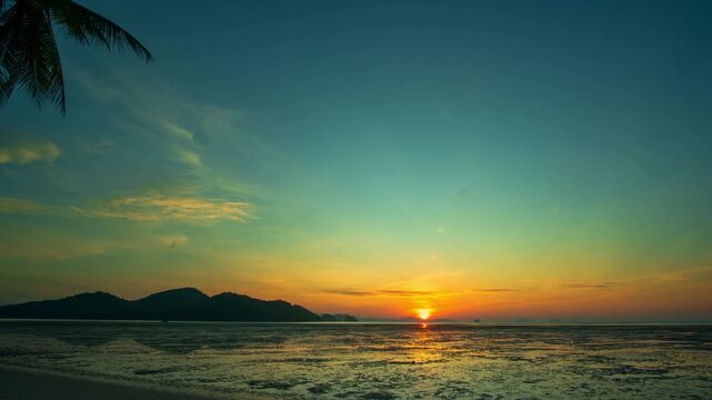 Time lapse beautiful Golden Light Shining on the Sandbar at Koh Yao Yai. When the tide is low, the golden sun reveals a long sand ridge stretching into the sea, glowing softly in the early light.