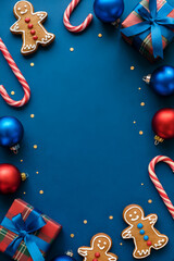 Christmas Gingerbread Cookies, Candy Canes, and Ornaments on Blue Background – Festive Holiday Flat Lay